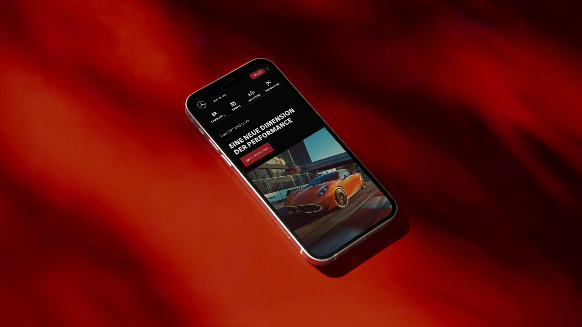 A mobile phone shows the AMG Homepage