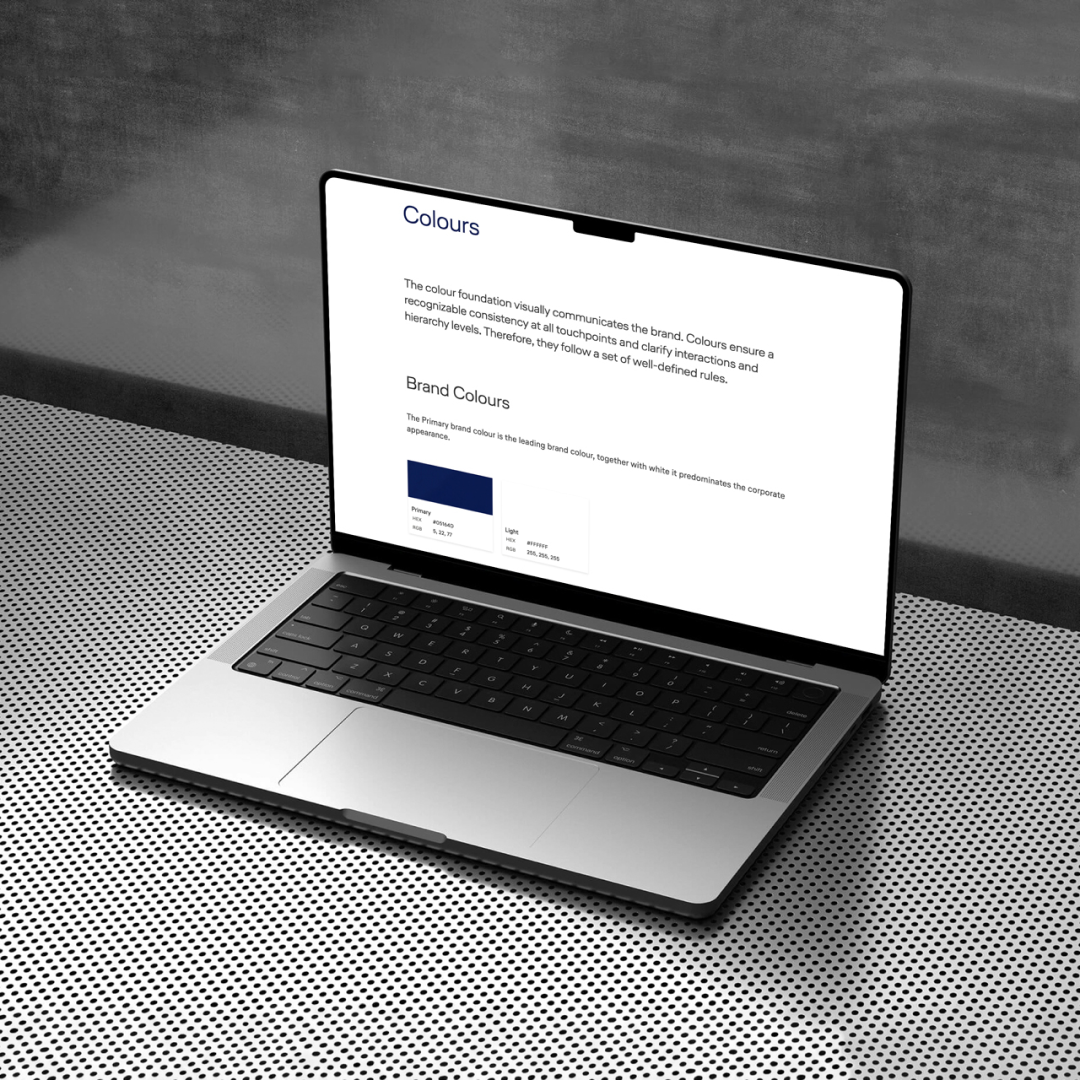 A laptop shows the miles and more design system documentation