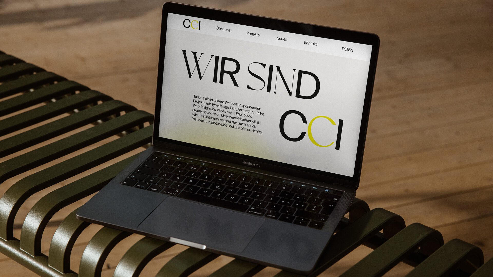 A laptop is laying on a bench and show the new CCI Institute Website