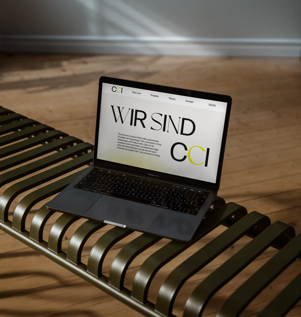 A laptop is laying on a bench and show the new CCI Institute Website