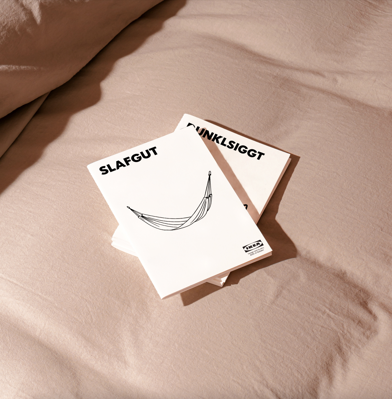 Ikea brochures of fictional products with typical Ikea names are lying on a bed