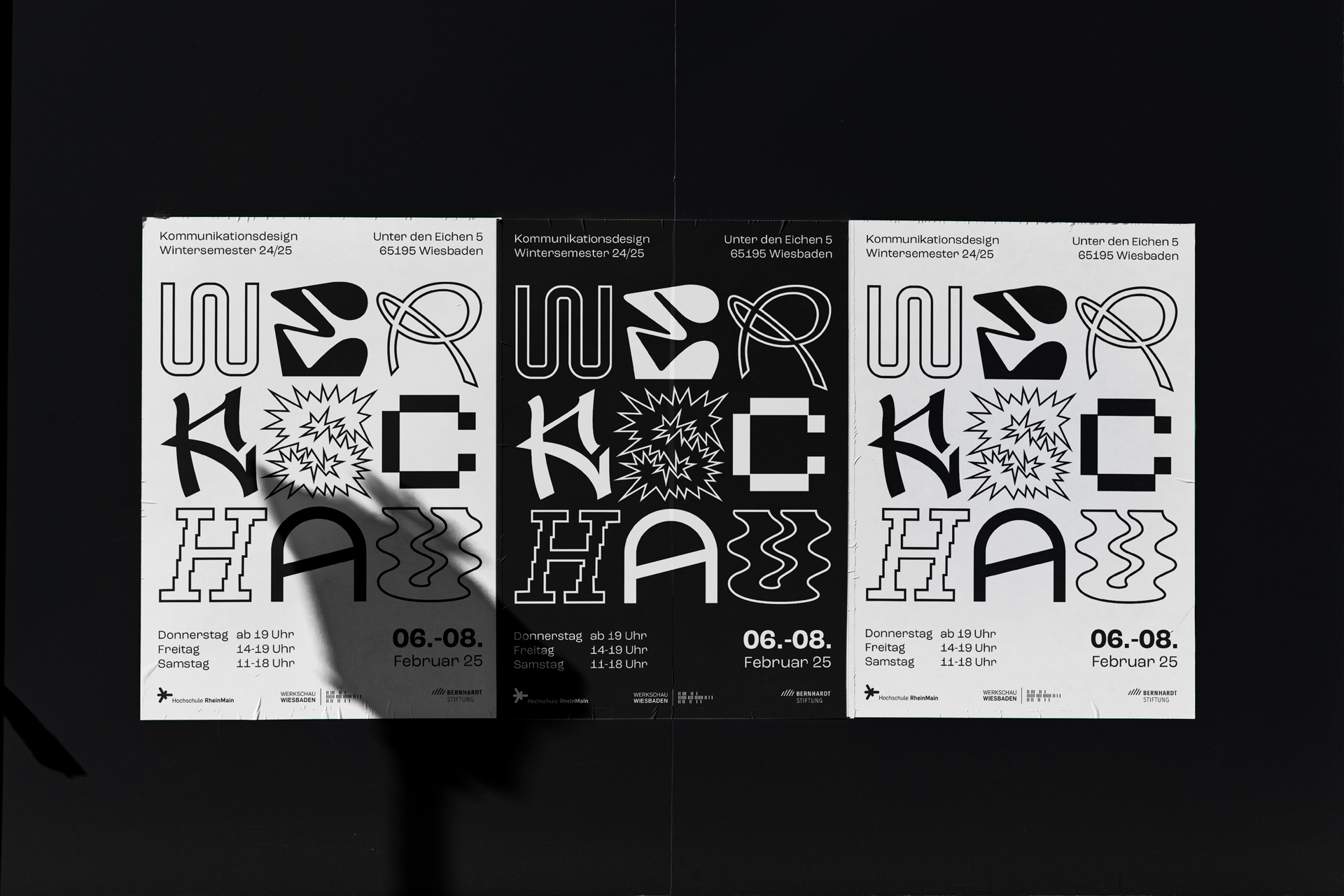 Three posters of the werkschau in different versions are hanging on a wall