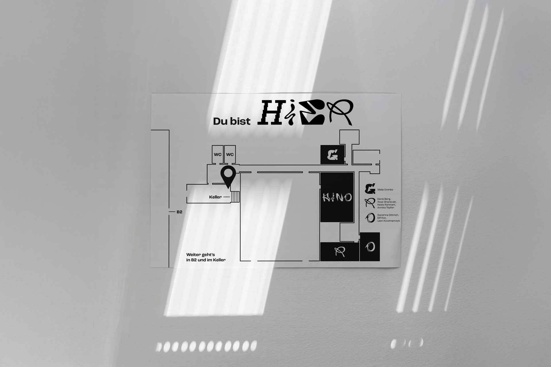A Room plan of the werkschau is hanging on a wall